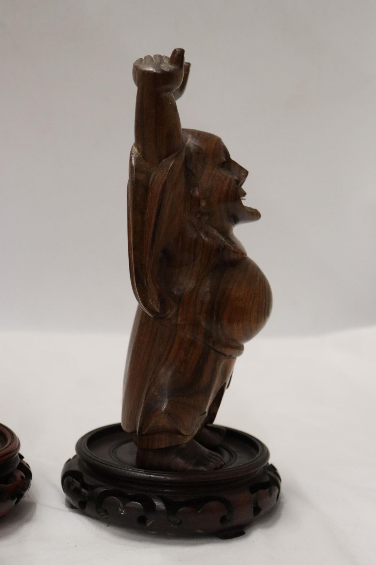 TWO CARVED WOODEN ORIENTAL FIGURES TO INCLUDE A LAUGHING BUDDAH, ON STANDS - Image 4 of 9