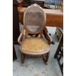 A VICTORIAN SATINWOOD ROCKING CHAIR WITH SPLIT CANE BACK