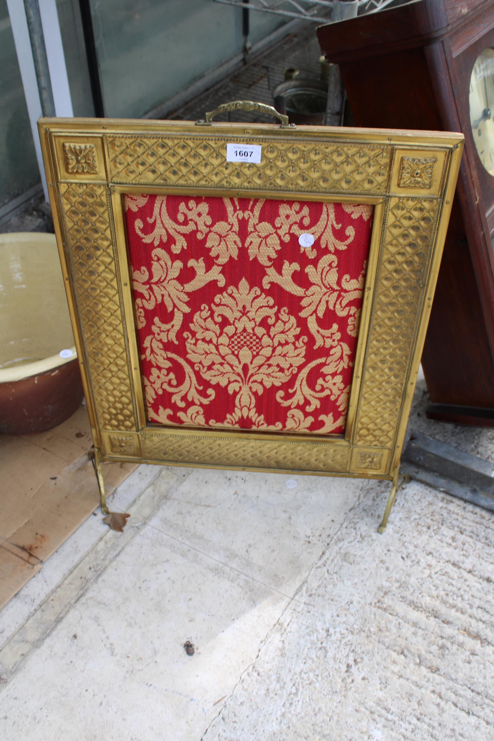 A DECORATIVE BRASS FIRE SCREEN WITH A TAPESTRY CENTRE