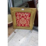 A DECORATIVE BRASS FIRE SCREEN WITH A TAPESTRY CENTRE