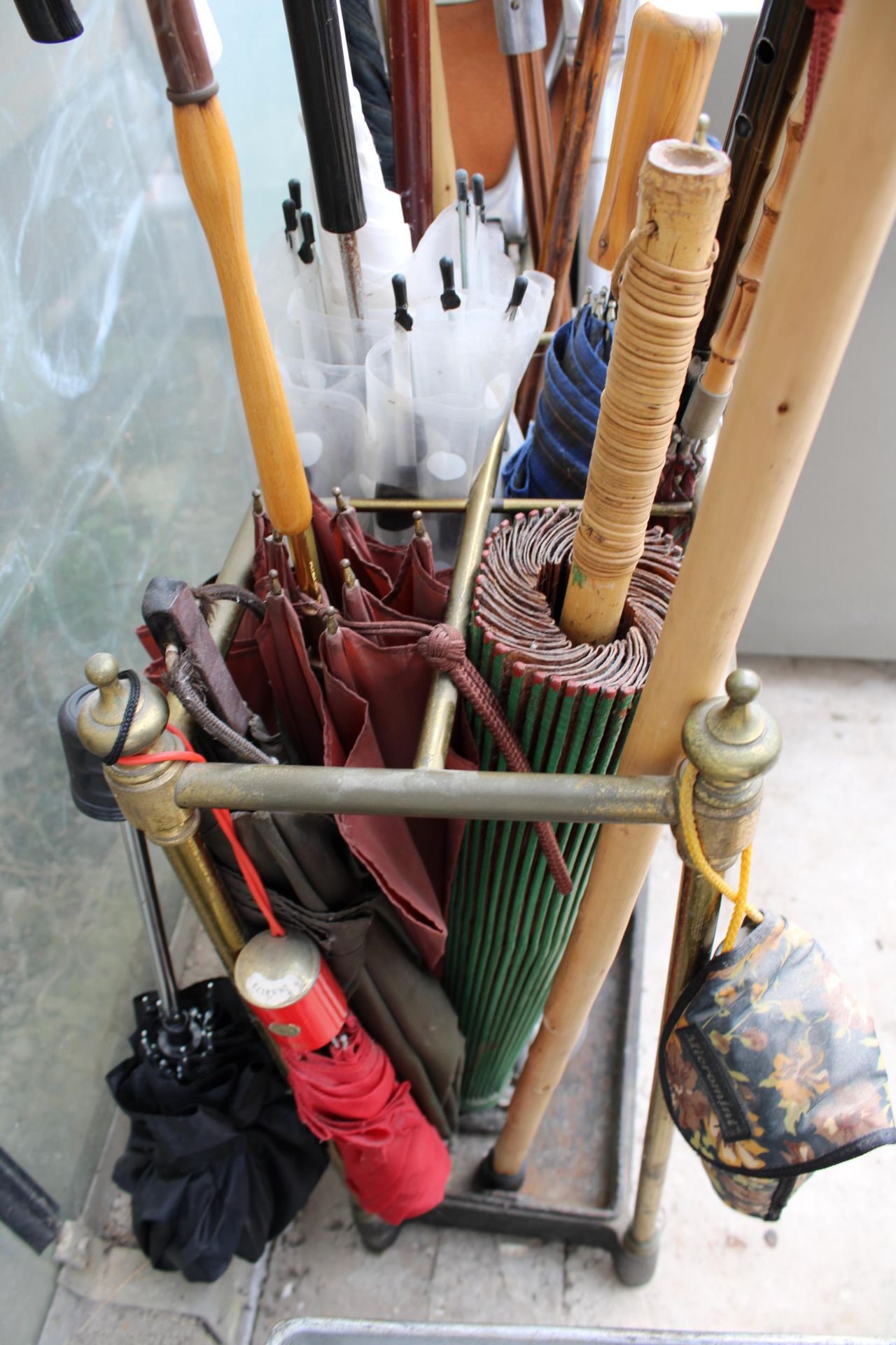 A VINTAGE CAST IRON AND BRASS COATED STICK STAND WITH A LARGE ASSORTMENT OF WALKING STICKS AND - Image 3 of 3