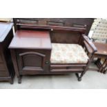 AN OAK TELEPHONE TABLE WITH SINGLE CUPBOARD AND DRAWER