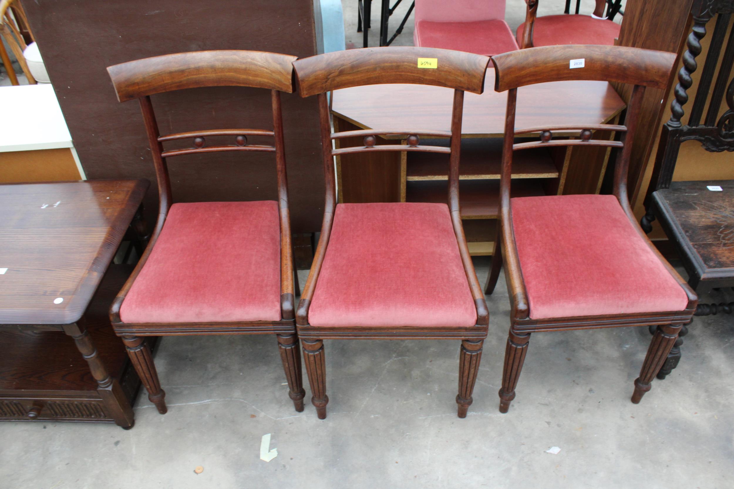 THREE VICTORIAN MAHOGANY DINING CHAIRS ON TURNED AND FLUTED LEGS