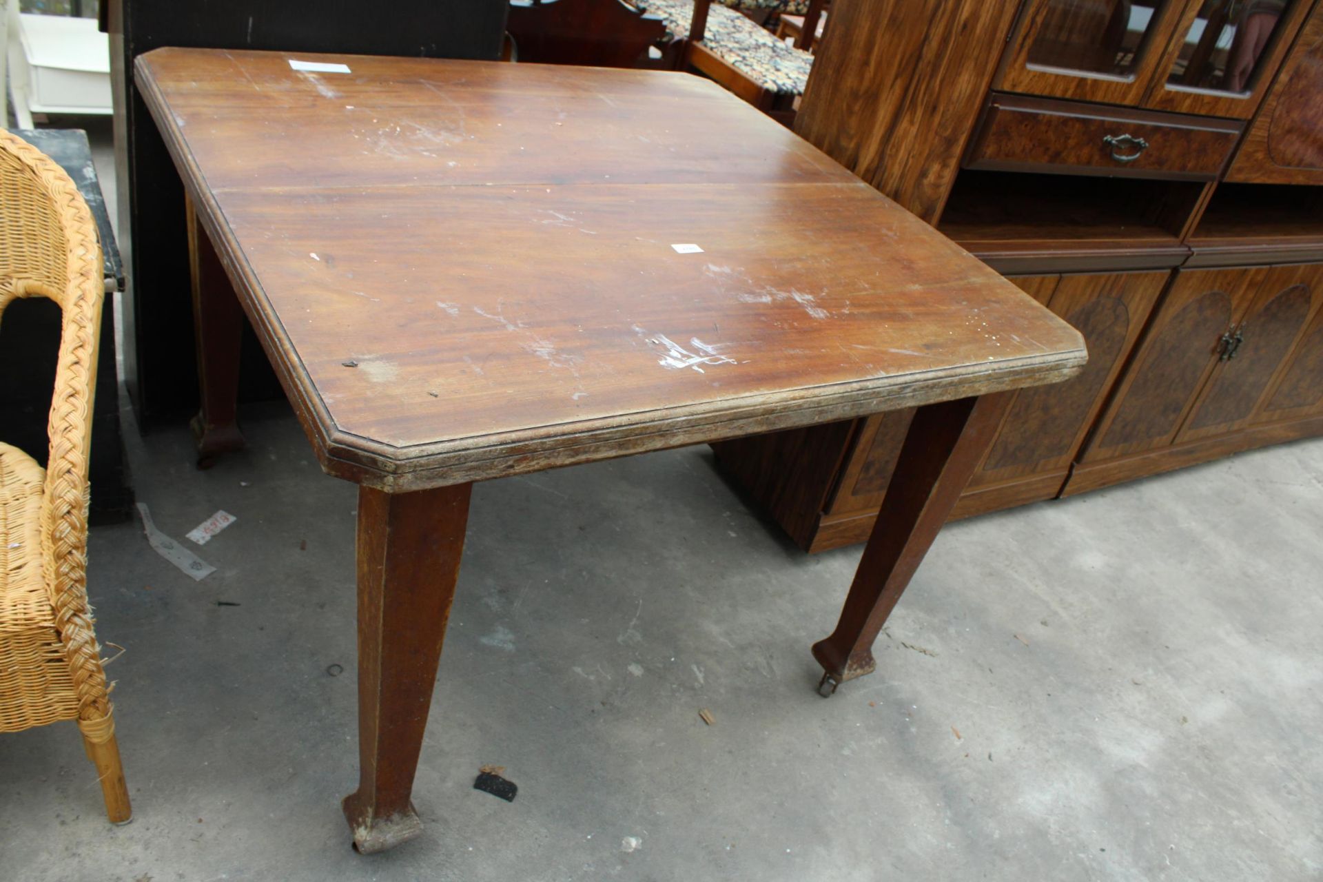 A LATE VICTORIAN WIND-OUT TABLE WITH CANTED CORNERS