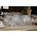 A QUANTITY OF CUT GLASS, GLASSES TO INCLUDE CHAMPAGNE FLUTES, WINE, BRANDY, SHERRY, ETC