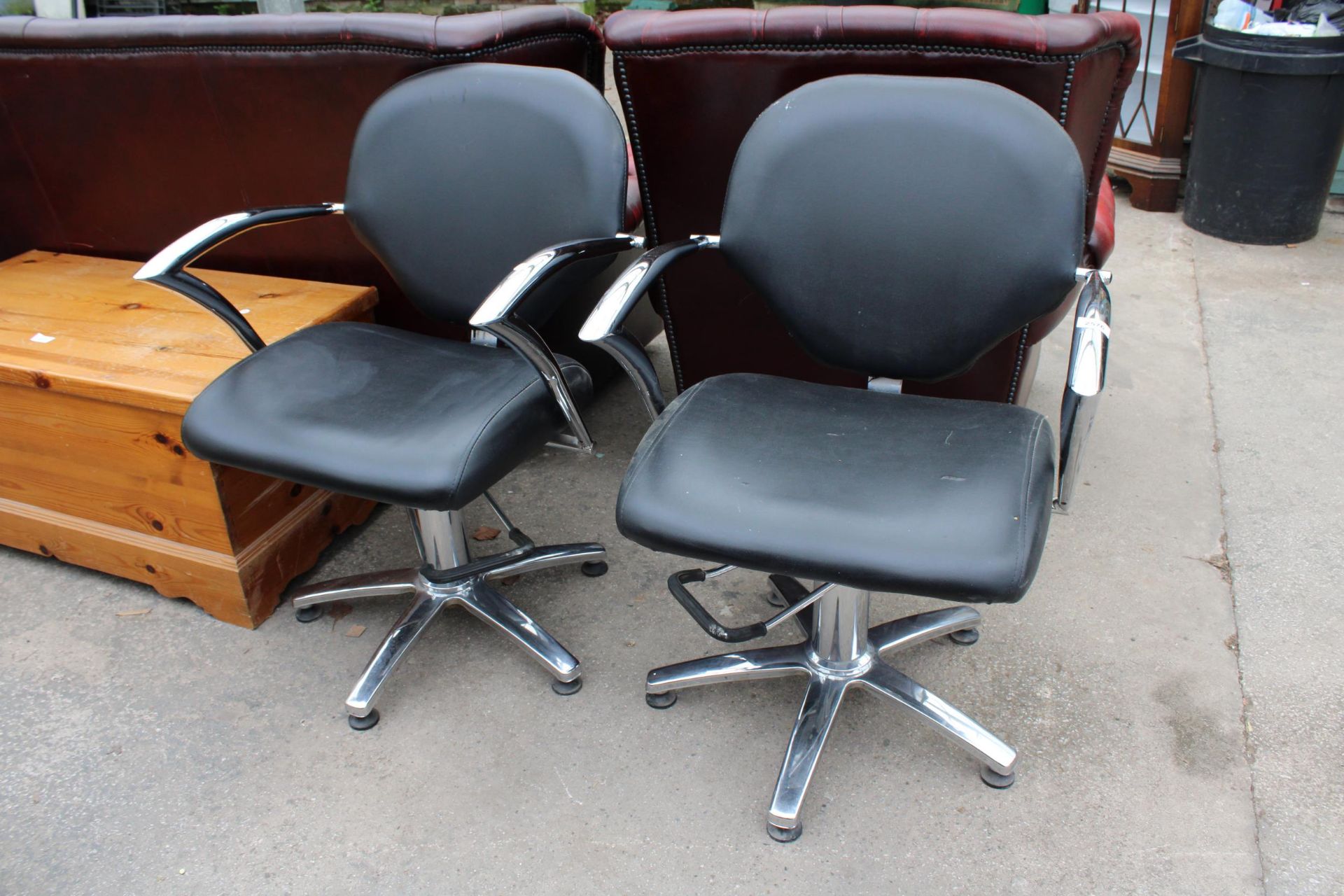 A PAIR OF BLACK FAUX LEATHER BARBERS STYLE SWIVEL PUMP CHAIRS ON POLISHED CHROME BASE WITH SWEPT