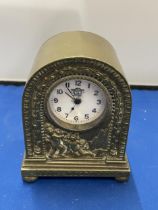 AN ITALIAN CLASSICAL BRASS MANTLE CLOCK WITH CHERUB DESIGN HEIGHT 12CM