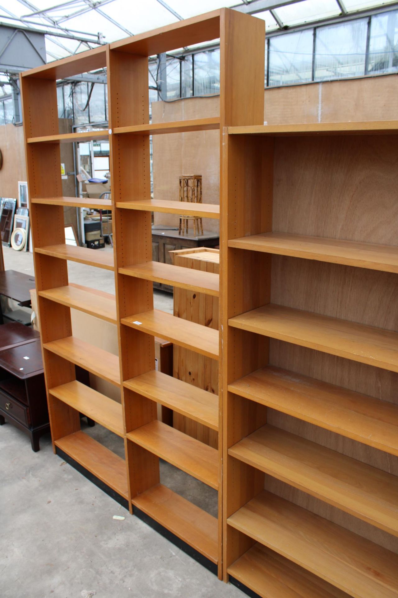 A FOURTEEN DIVISION OPEN BOOKCASE 53" WIDE