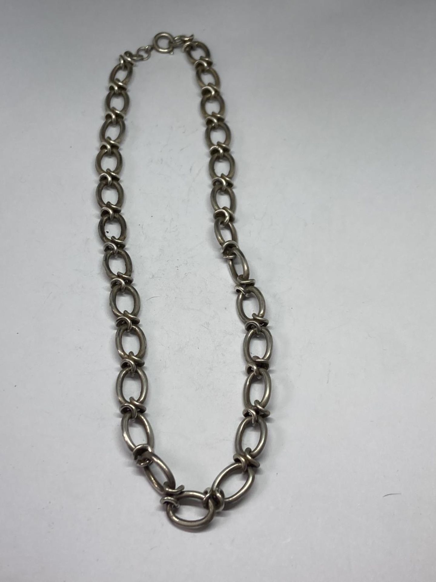 A HEAVY SILVER NECK CHAIN