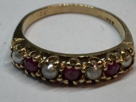 A 9 CARAT GOLD RING WITH FOUR SEED PEARLS AND THREE RED STONES IN A LINE GROSS WEIGHT 2.18 GRAMS