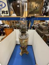 AN ORNATE VICTORIAN OIL LAMP WITH GLASS FUNNEL