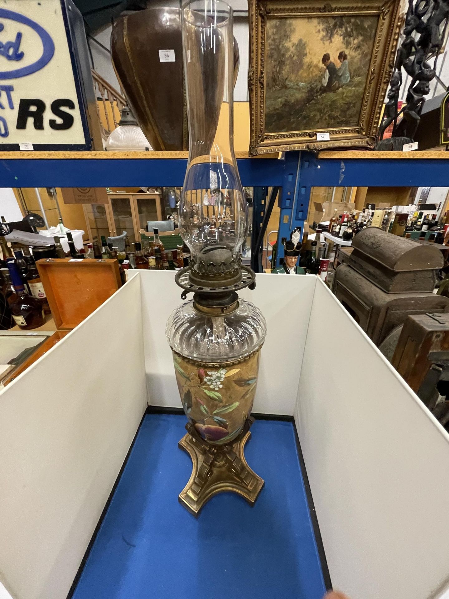 AN ORNATE VICTORIAN OIL LAMP WITH GLASS FUNNEL