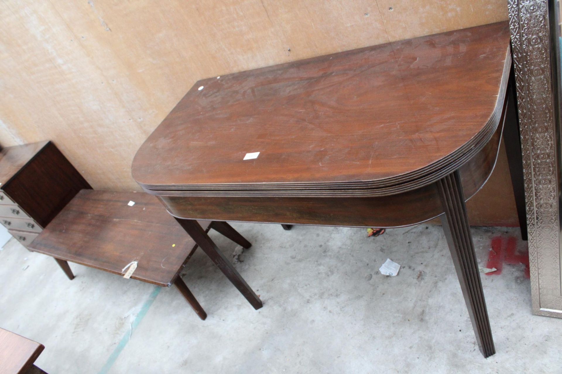 A 19TH CENTURY MAHOGANY FOLD OUT TEA TABLE ON TAPERED AND FLUTED LEGS