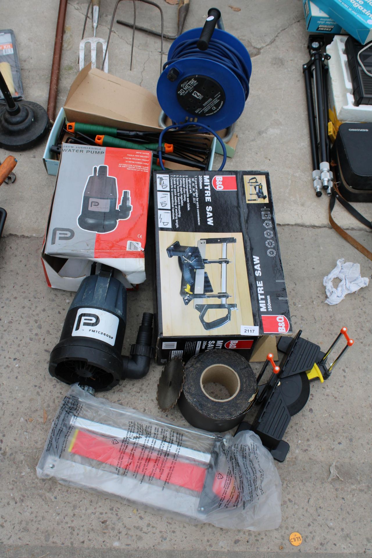 AN ASSORTMENT OF TOOLS TO INCLUDE A WATER PUMP, A SMALL MITRE SAW AND AN EXTENSION LEAD ETC