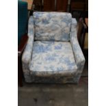 A LOW EASY CHAIR WITH FLORAL COVER
