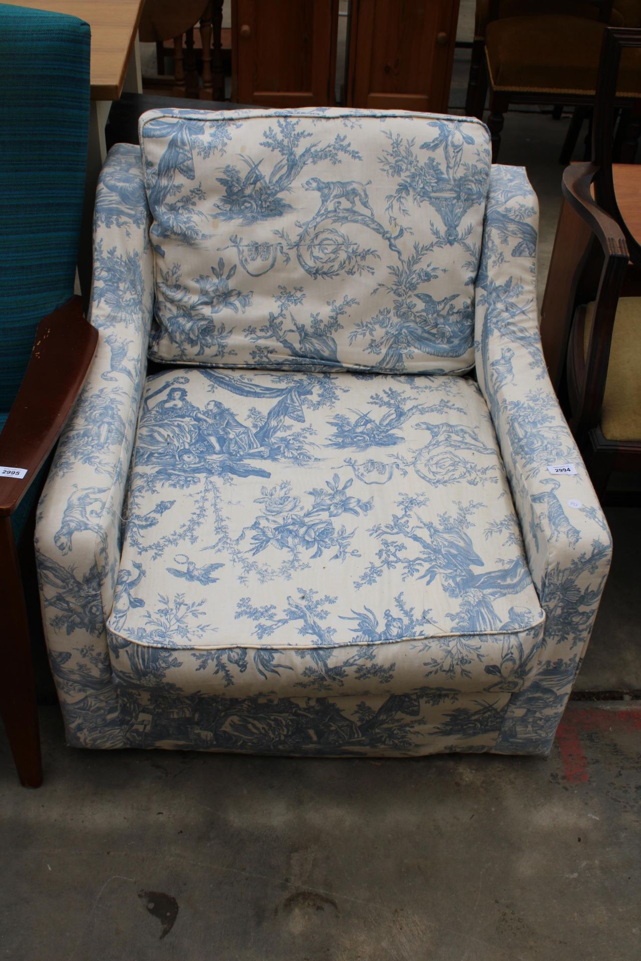A LOW EASY CHAIR WITH FLORAL COVER