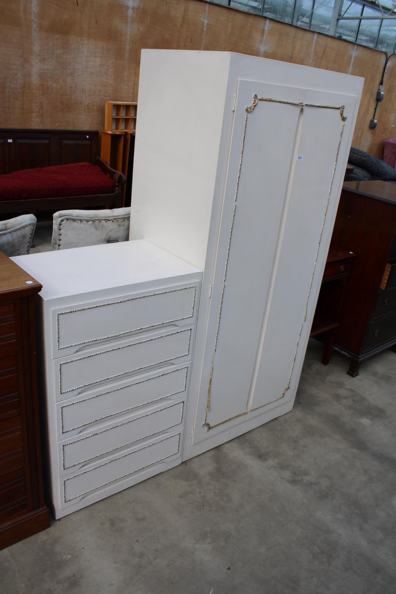 A WHITE AND GILT TWO DOOR WARDROBE AND MATCHING FIVE DRAWER CHEST