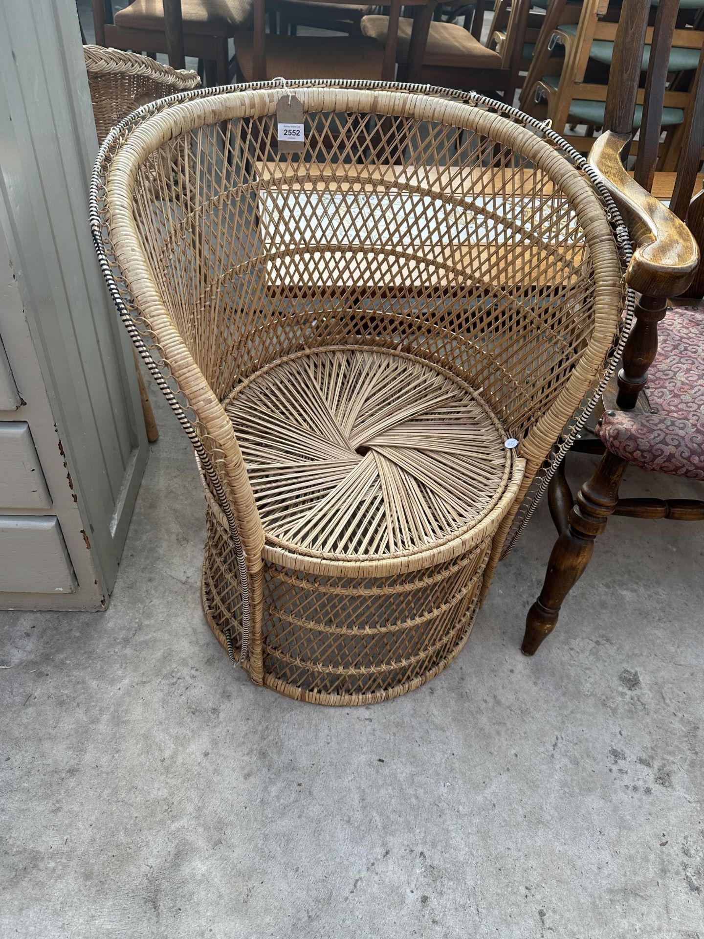 A VINTAGE WICKER BARREL CHAIR