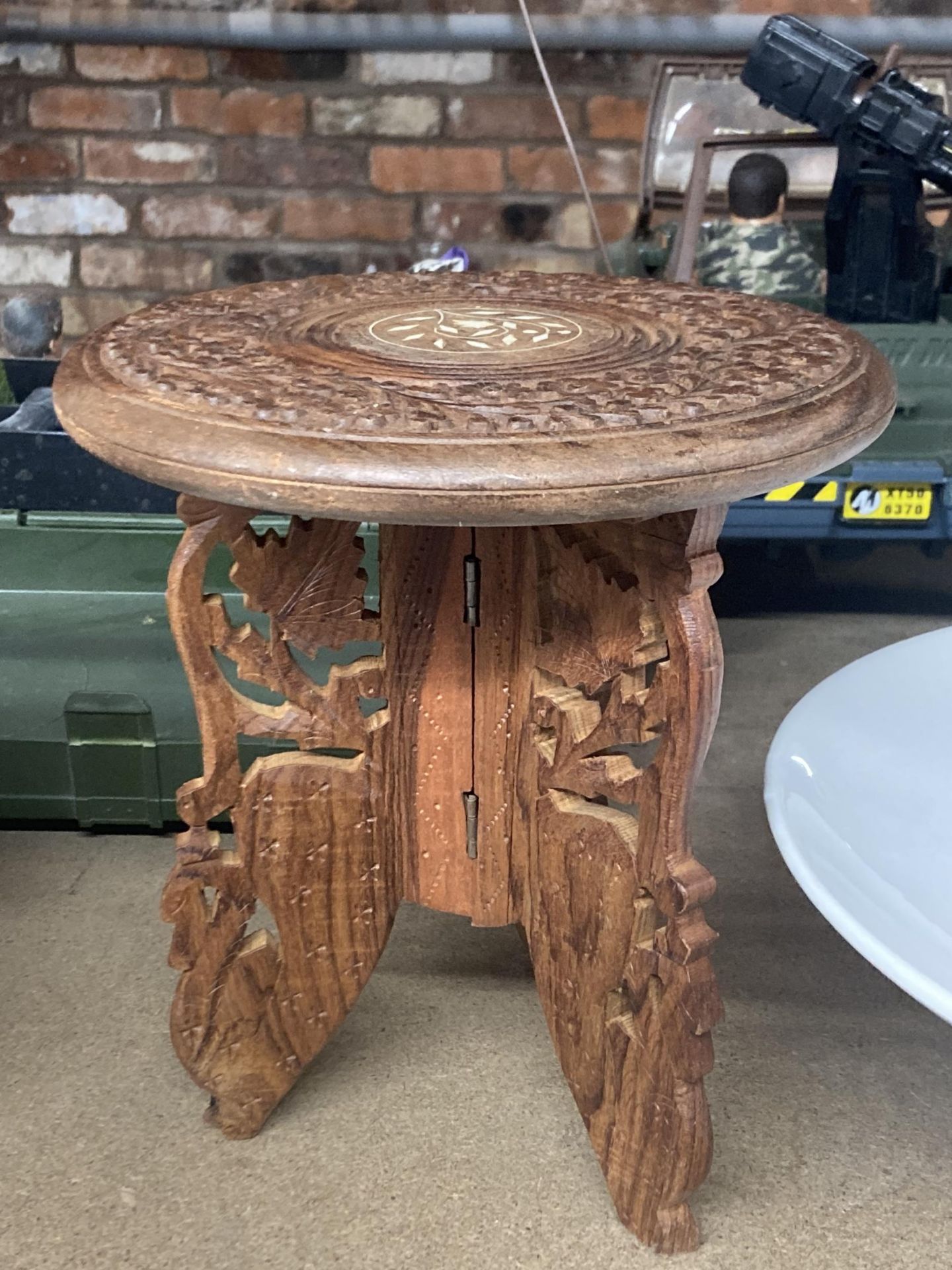 A CARVED INDIAN WOOD TABLE HEIGHT APPROXIMATELY 25CM
