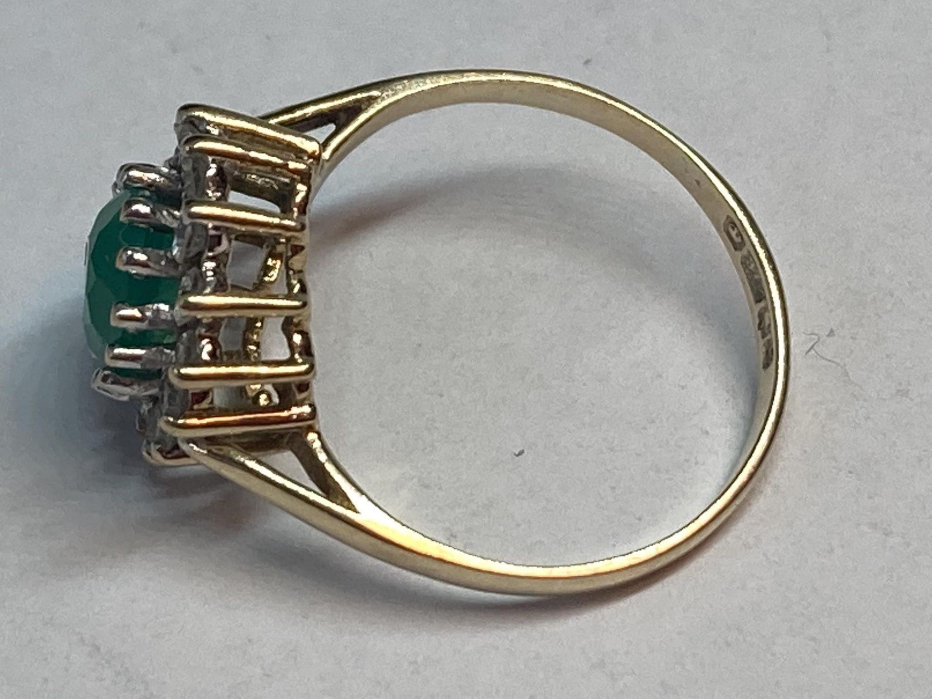 A 9 CARAT GOLD RING WITH CENTRE GREEN STONE SURROUNDED BY CUBIC ZIRCONIAS SIZE K - Image 2 of 3