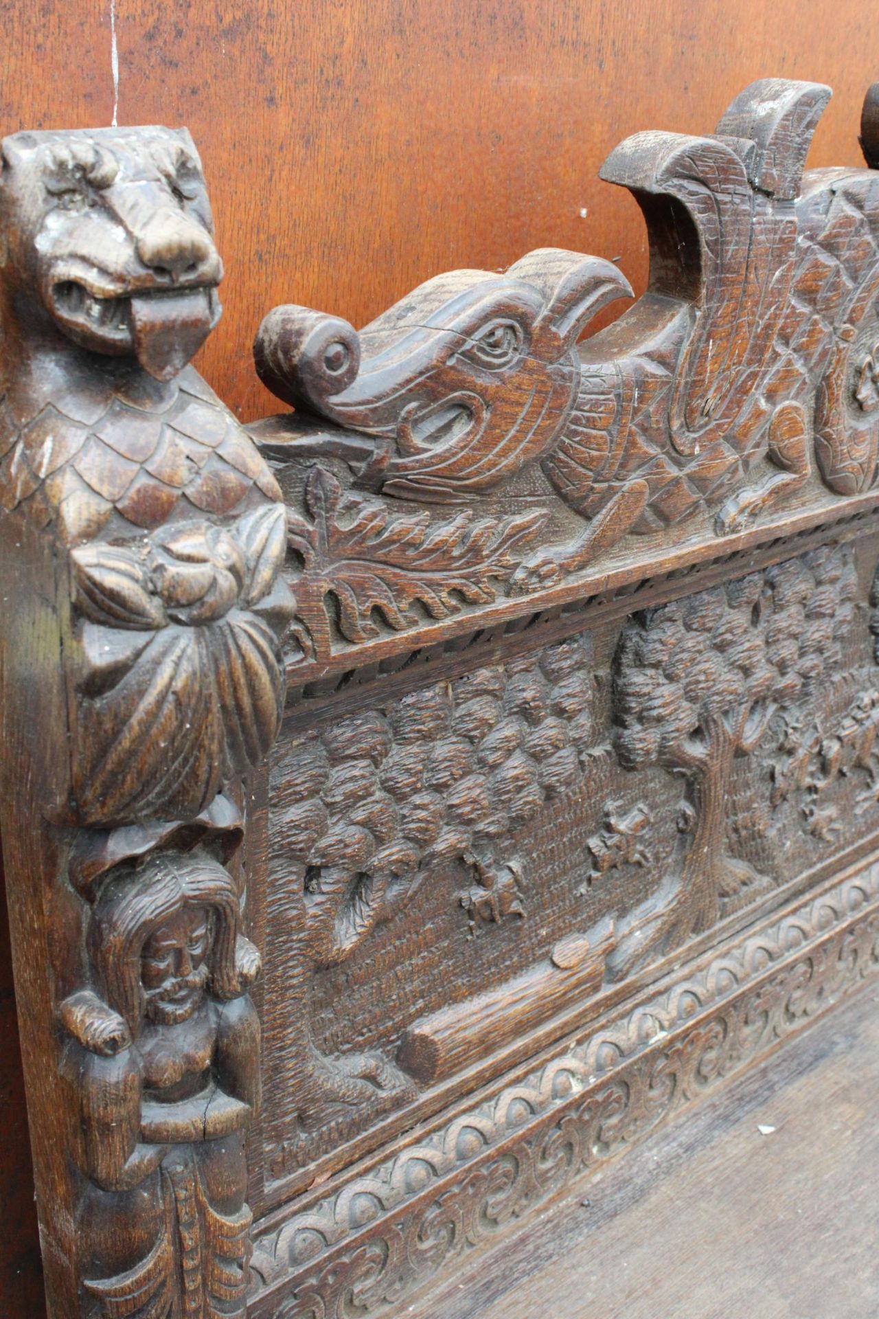 A HEAVILY CARVED GOTHIC OAK SIDEBOARD WITH DEER HUNTING SCENE AND MYTHICAL FIGURE, RAISED BACK, - Image 5 of 5