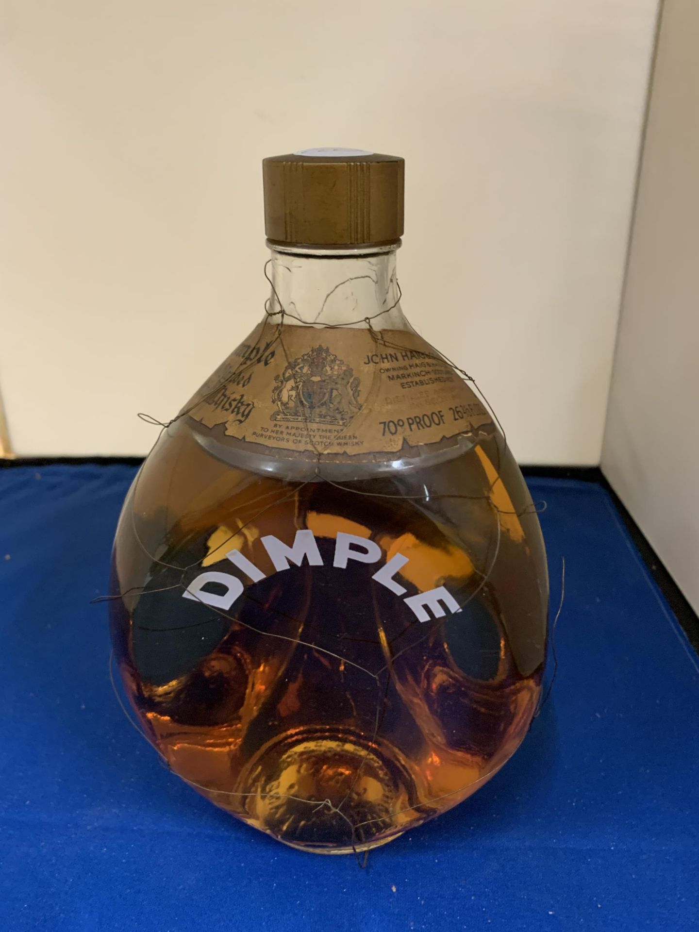 A DIMPLE BOTTLE OF JOHN HAIGH & CO LIMITED WHISKY 70% PROOF