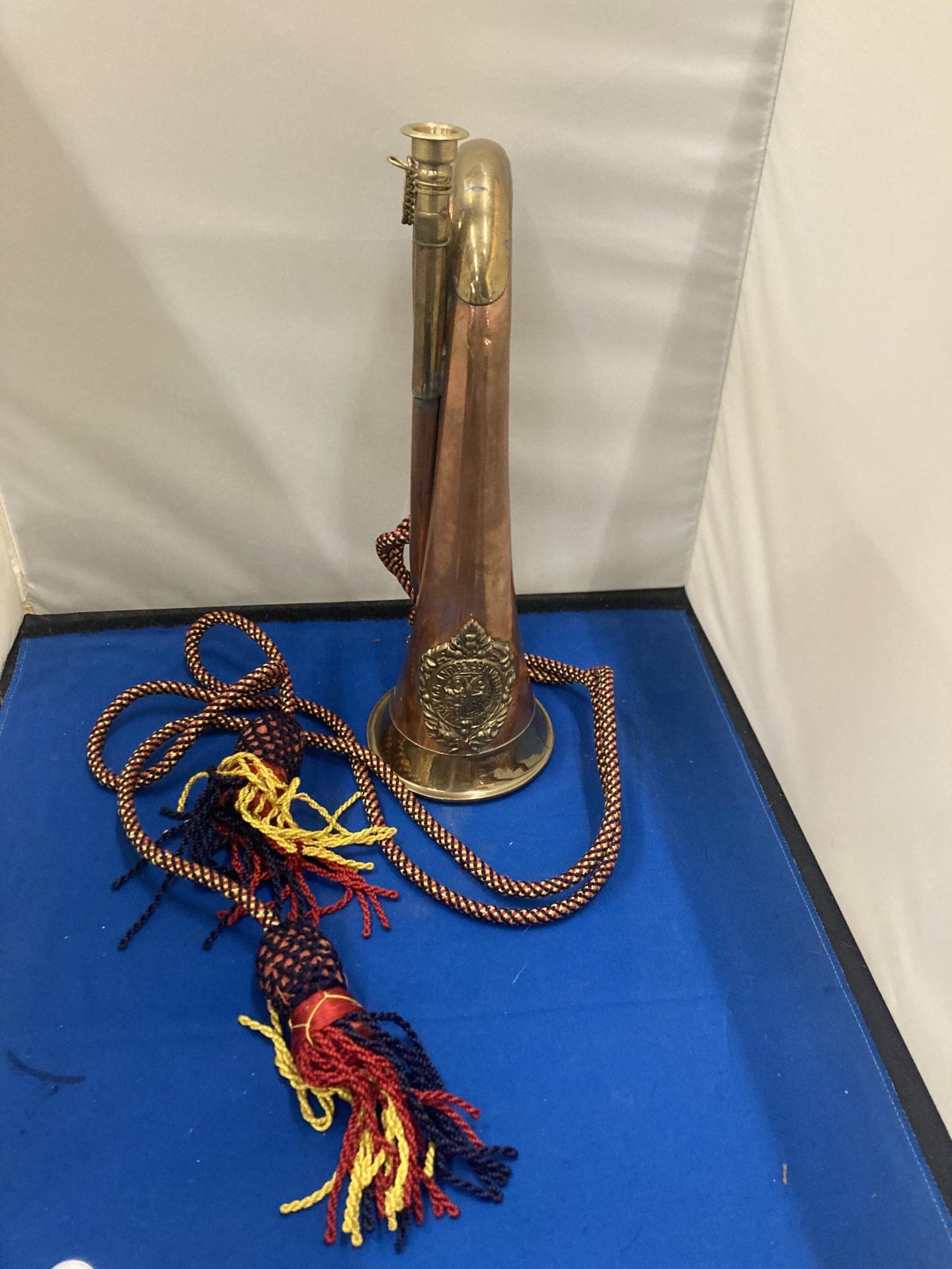 A BRASS AND COPPER 20TH CENTURY BUGLE WITH AN ARGYLE AND SUTHERLAND REGIMENTAL CREST AND CORD