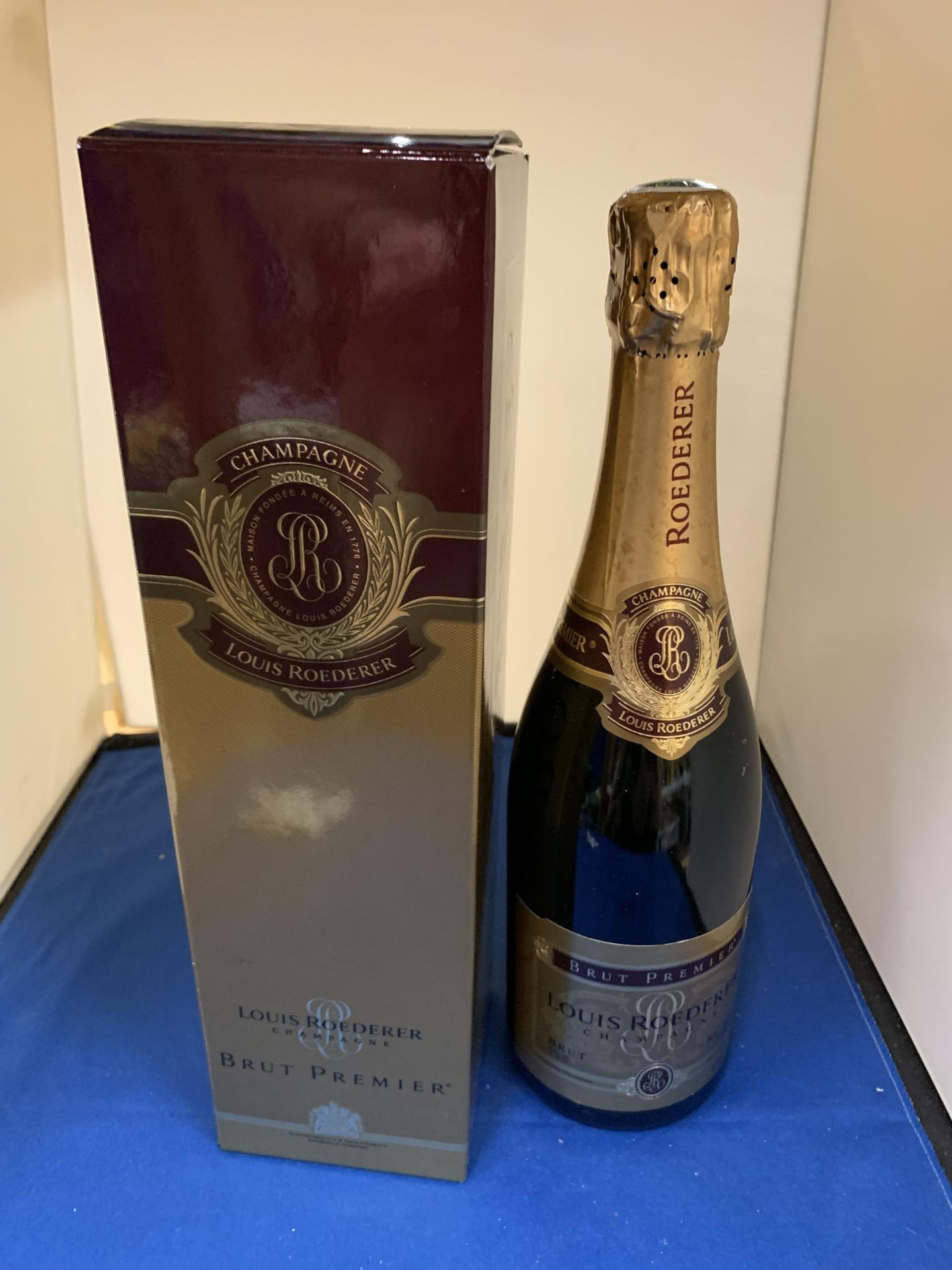 A BOXED BOTTLE OF LOUIS ROEDERER BRUT PREMIER CHAMPAGNE