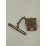 A HALLMARKED 9CT GOLD DIAMOND AND RUBY 'FODEN' PIN BADGE GROSS WEIGHT 4.84G