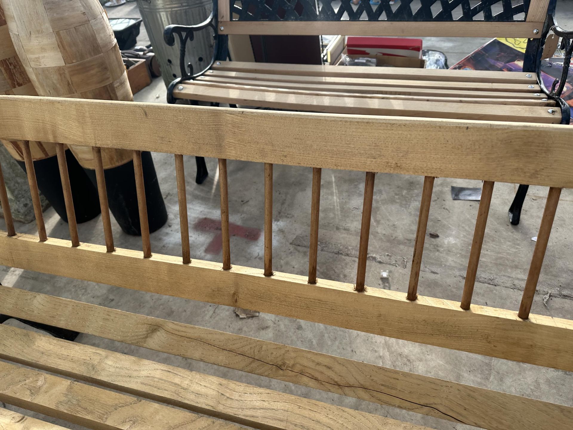 A WOODEN SLATTED GARDEN BENCH WITH CAST BENCH ENDS - Image 2 of 3