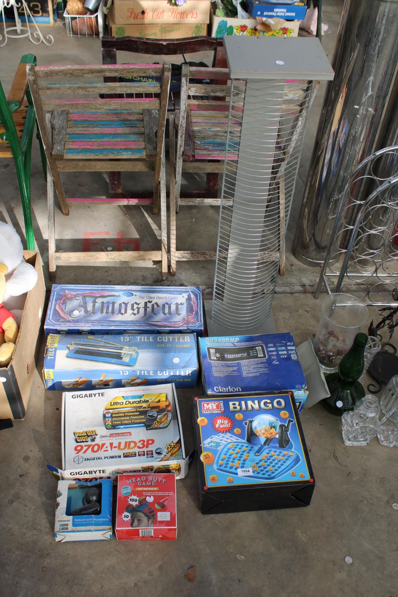 AN ASSORTMENT OF ITEMS TO INCLUDE A TILE CUTTER, A CD RACK AND BOARD GAMES ETC