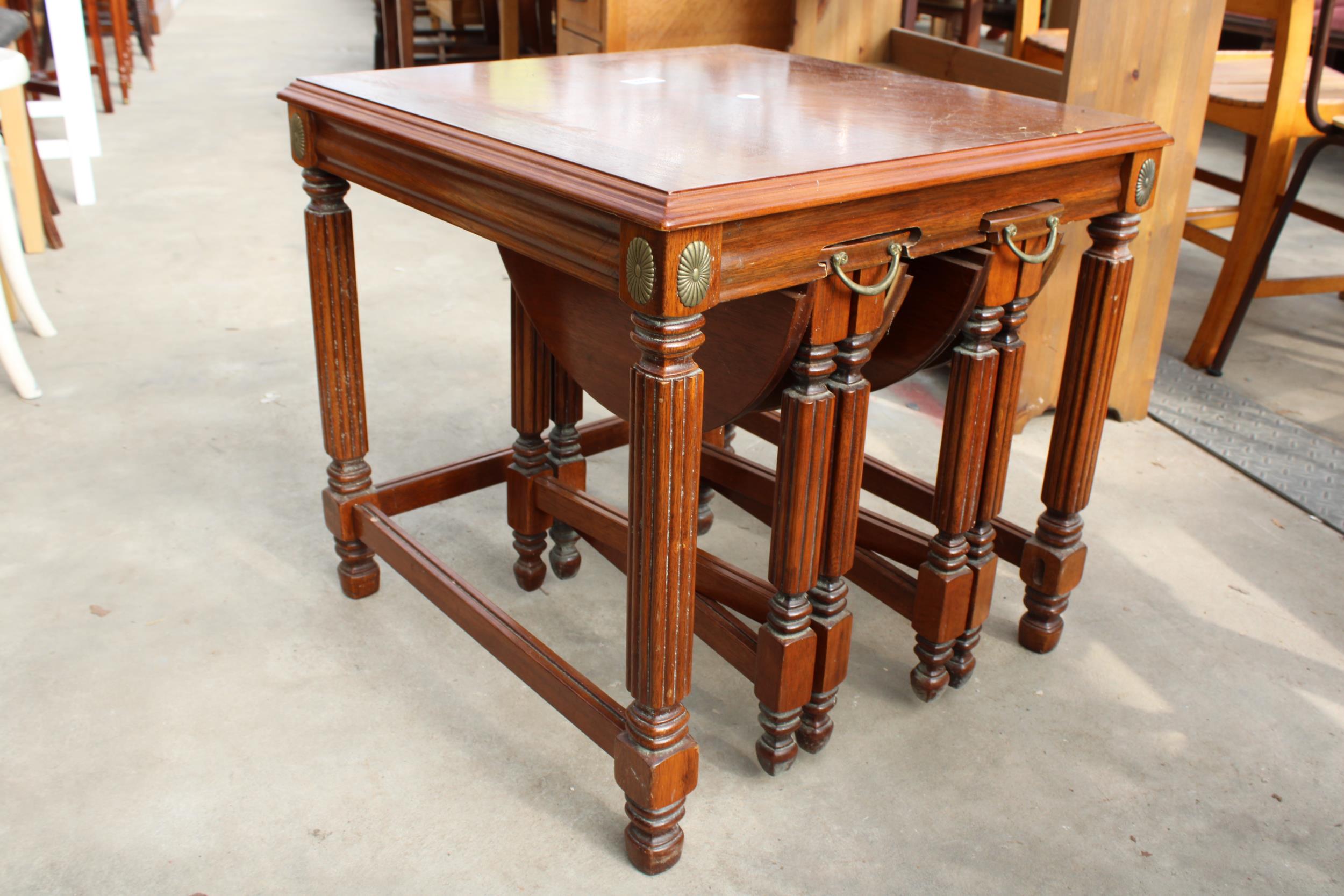 A HARDWOOD NEST OF THREE TABLES , TWO BEING DROP LEAF 17" DIAMETER - Image 2 of 3