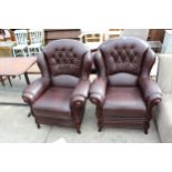 A PAIR OF RED LEATHER EASY CHAIRS WITH PARTIAL WING BACKS