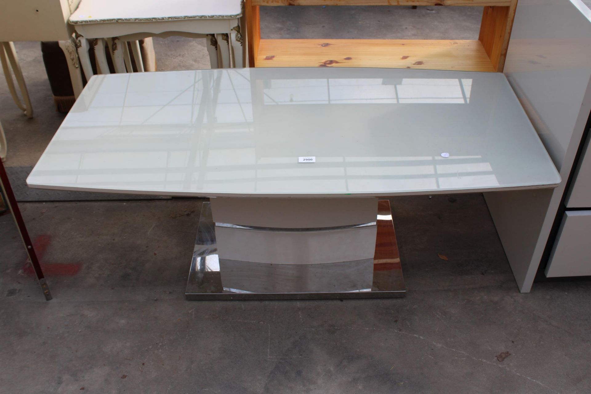 A MILAN STYLE COFFEE TABLE WITH GLASS TOP AND POLISHED CHROME BASE 47" X 24"