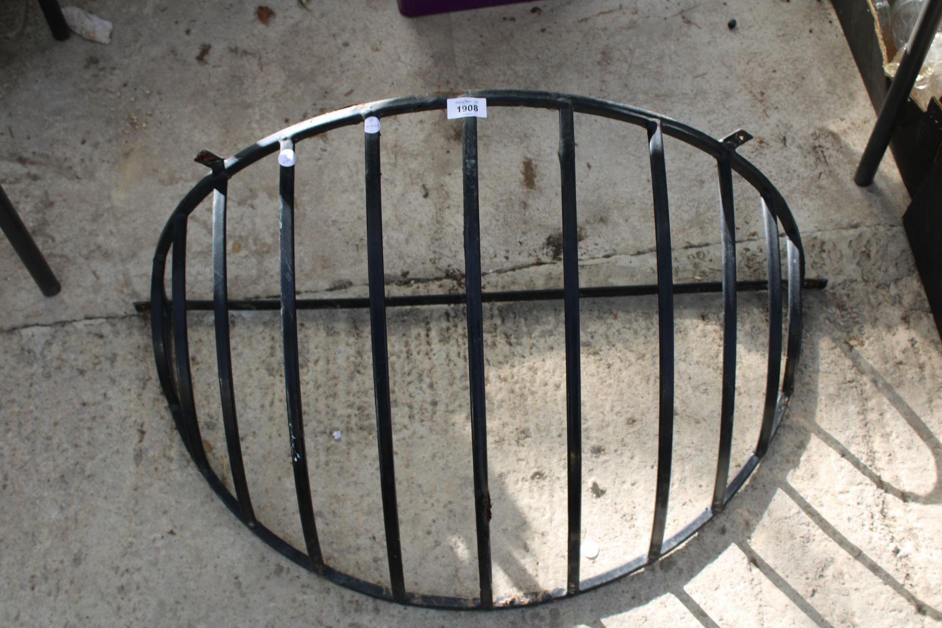 A METAL HAYRACK PLANTER