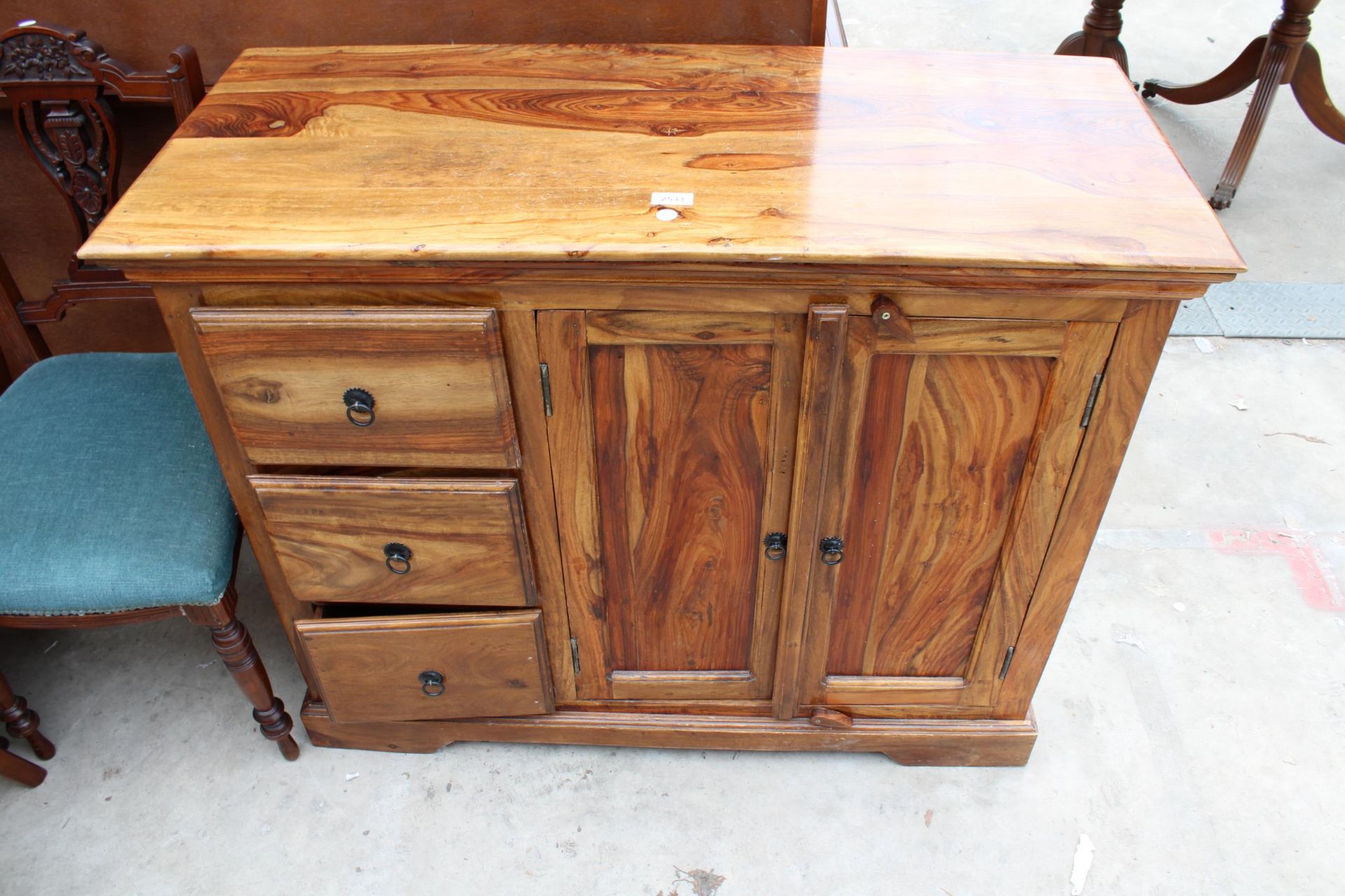 A HARDWOOD SIDEBOARD ENCLOSING THREE DRAWERS AND TWO CUPBOARDS 42" WIDE