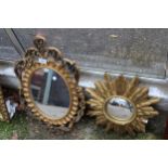 A GILT EFFECT STARBURST MIRROR AND OVAL MIRROR