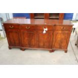 A MAHOGANY AND CROSS BANDED BREAKFRONT REPRODUX SIDEBOARD ENCLOSING FOUR DRAWERS AND FOUR CUPBOARDS,