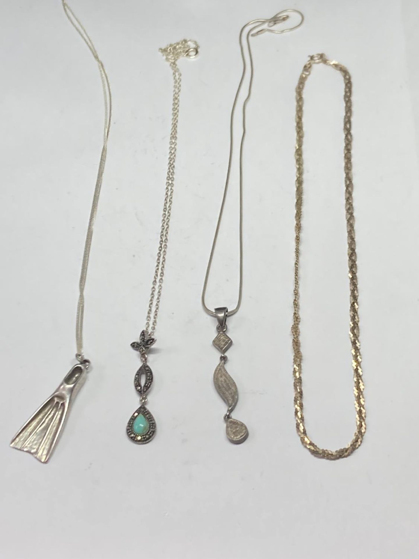 FOUR SILVER NECKLACES THREE WITH PENDANTS