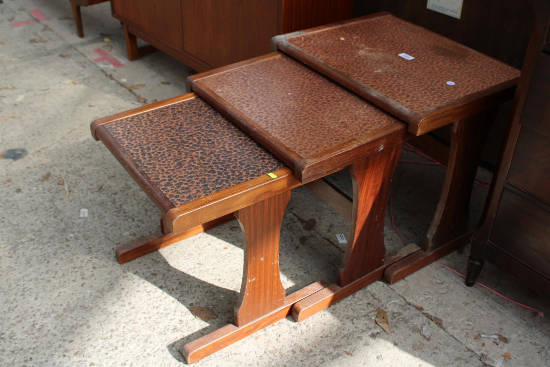 A RETRO TEAK G PLAN NEST OF THREE TABLES WITH EMBOSSED COPPER TOPS - Image 2 of 3