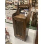 A VINTAGE OAK SMOKERS CABINET WITH CARVED DOOR