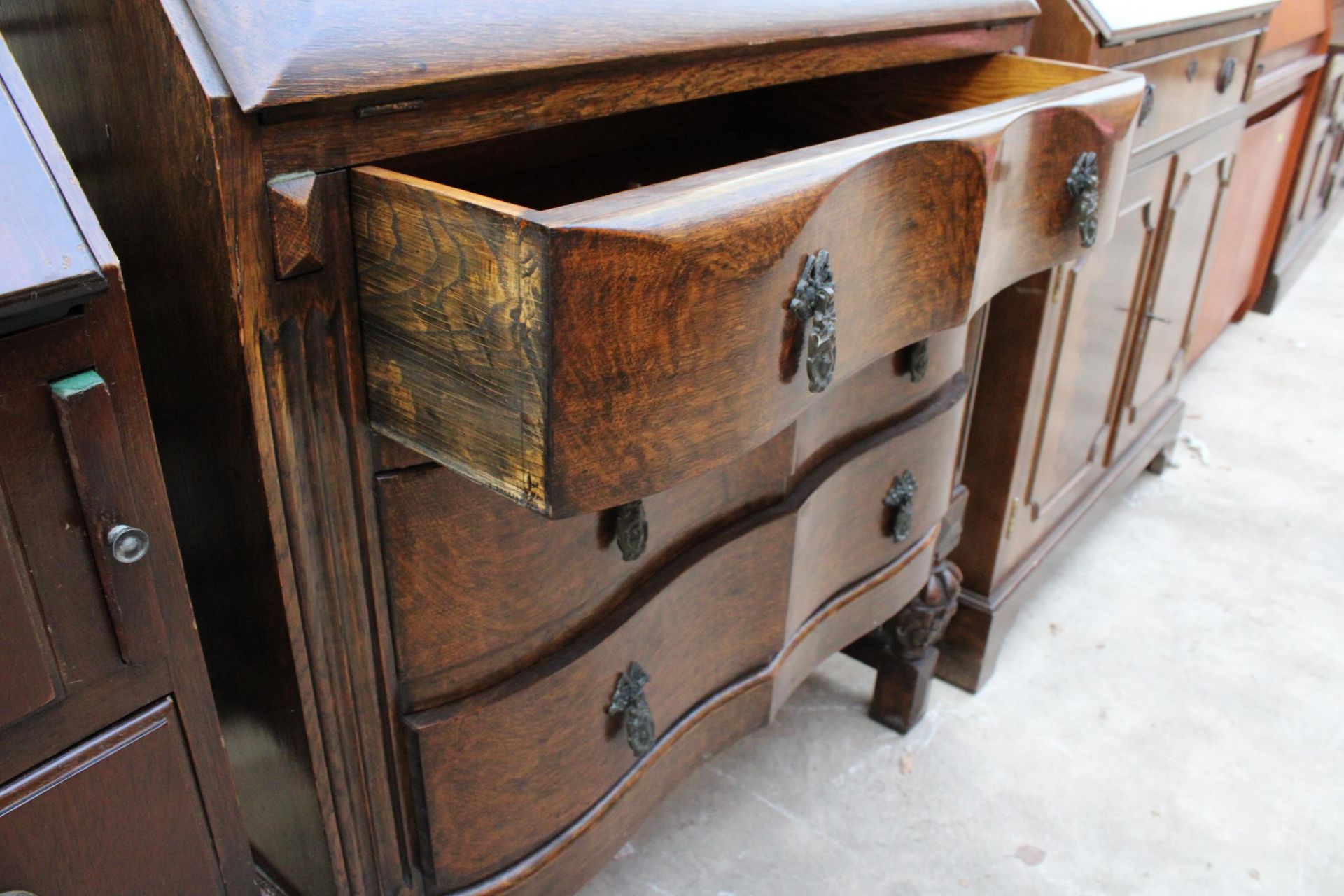 A EARLY 20TH CENTURY OAK SERPENTINE FRONTED BUREAU BOOKCASE WITH RETRACTABLE FITTED INTERIOR 29" - Image 6 of 6