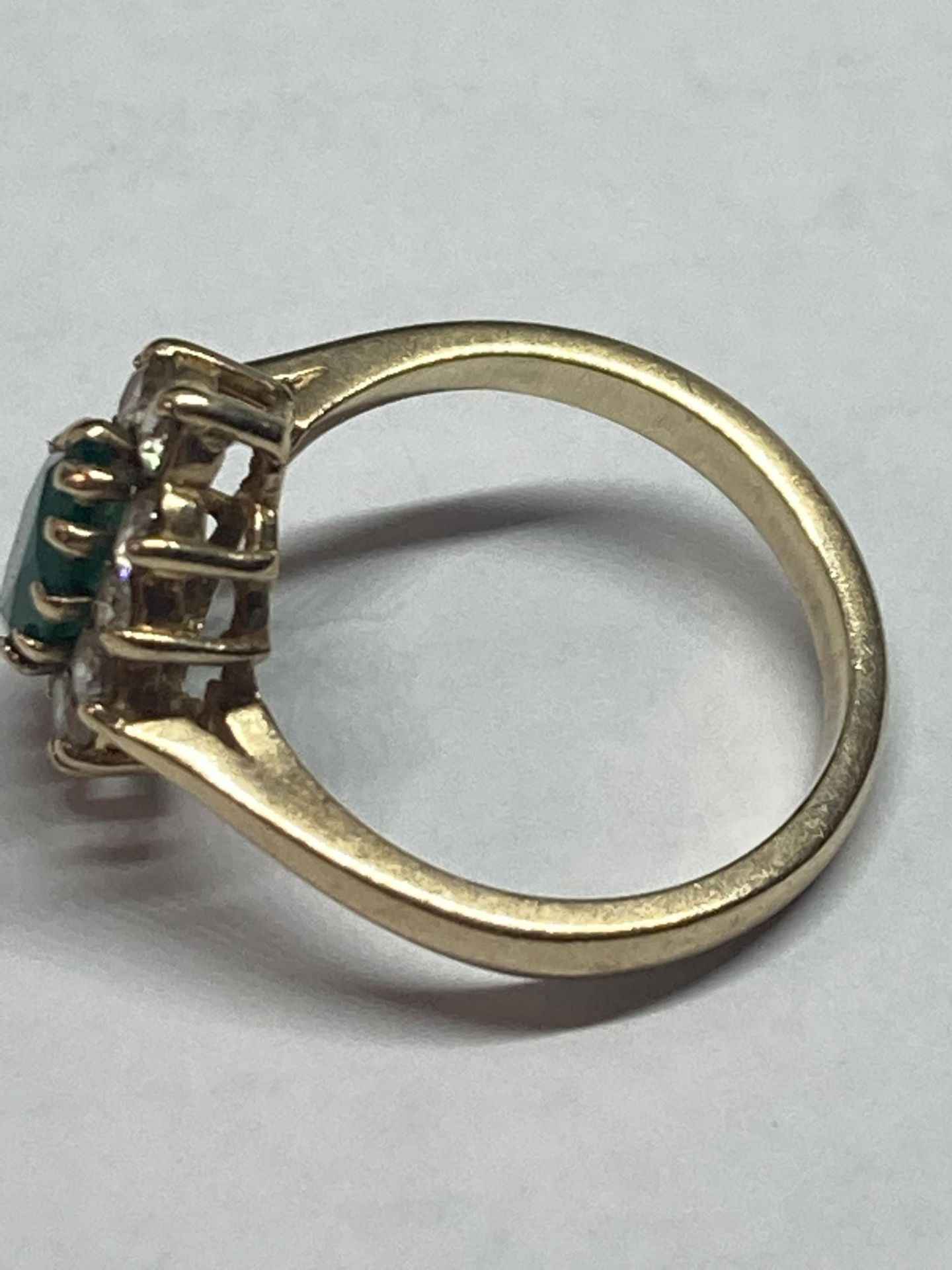 A 9 CARAT GOLD RING WITH A CENTRE EMERALD SURROUNDED BY CUBIC ZIRCONIAS SIZE L - Image 2 of 4