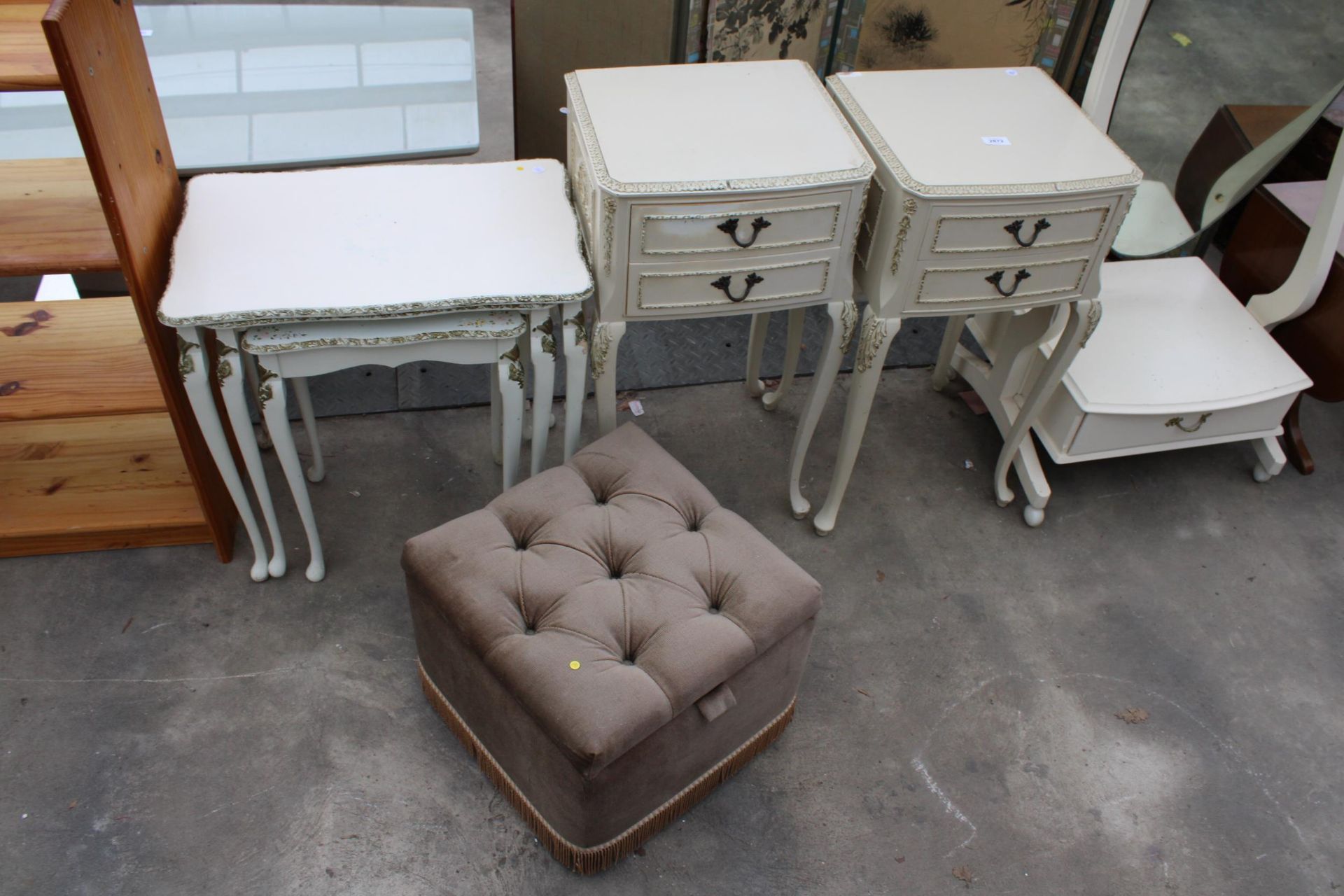 A PAIR OF CREAM AND GILT BEDSIDE TABLES, NEST OF TWO TABLES AND A POUFFE