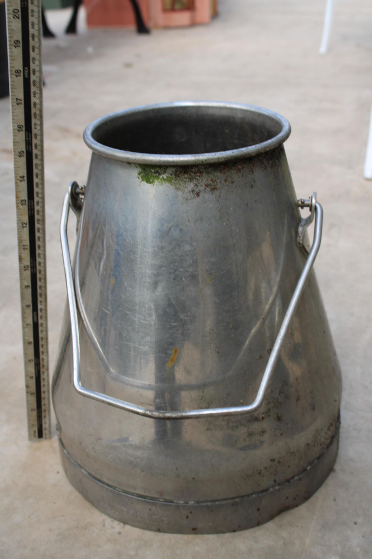 A HAND PAINTED STAINLESS STEEL MILKING BUCKET