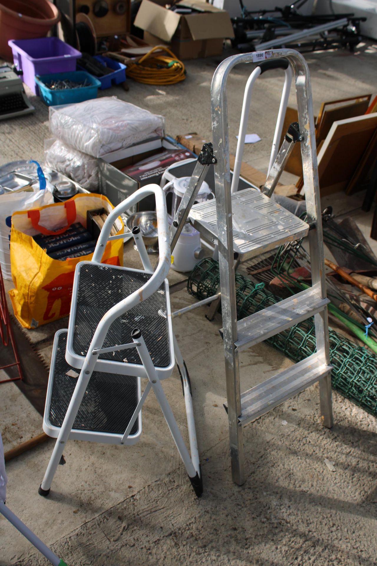 A TWO RUNG ALUMINIUM STEP LADDER AND A TWO RUNG NON SLIP LADDER