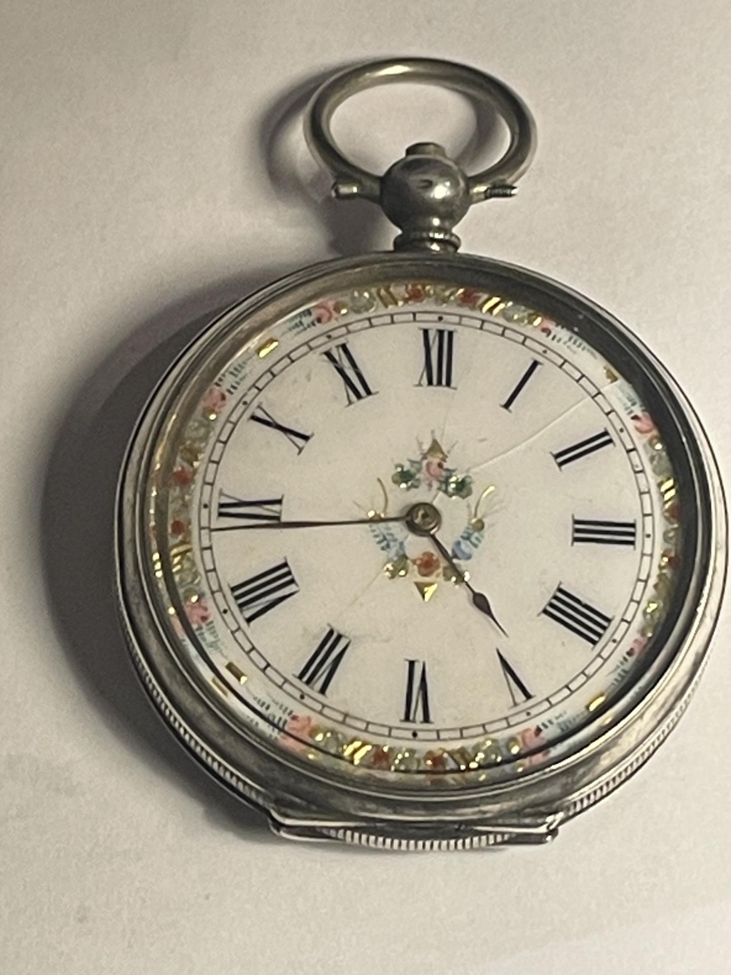 A MARKED 800 SILVER DECORATIVE LADIES POCKET WATCH WITH INLAID WHITE ENAMEL FACE (A/F) AND ROMAN