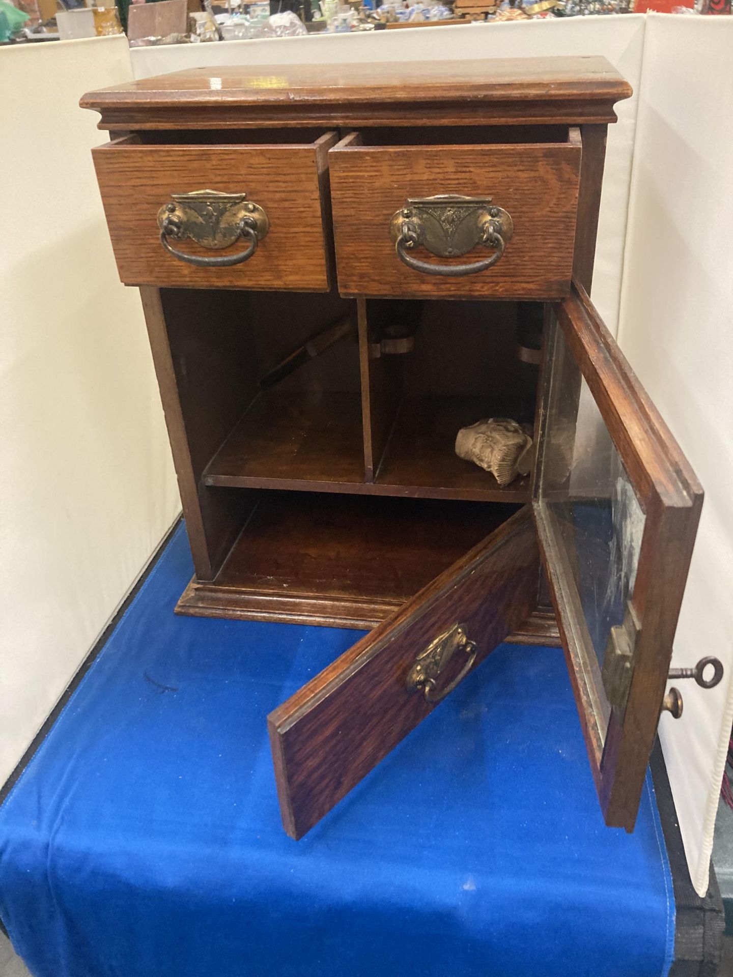 A VINTAGE OAK SMOKERS CABINET WITH TWO SHORT UPPER DRAWERS, A GLAZED DOOR AND A LONG LOWER DRAWER - Image 2 of 7