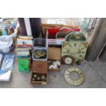 AN ASSORTMENT OF VINTAGE CLOCK PARTS TO INCLUDE FACES, COGS AND BOOKS ON CLOCKS ETC