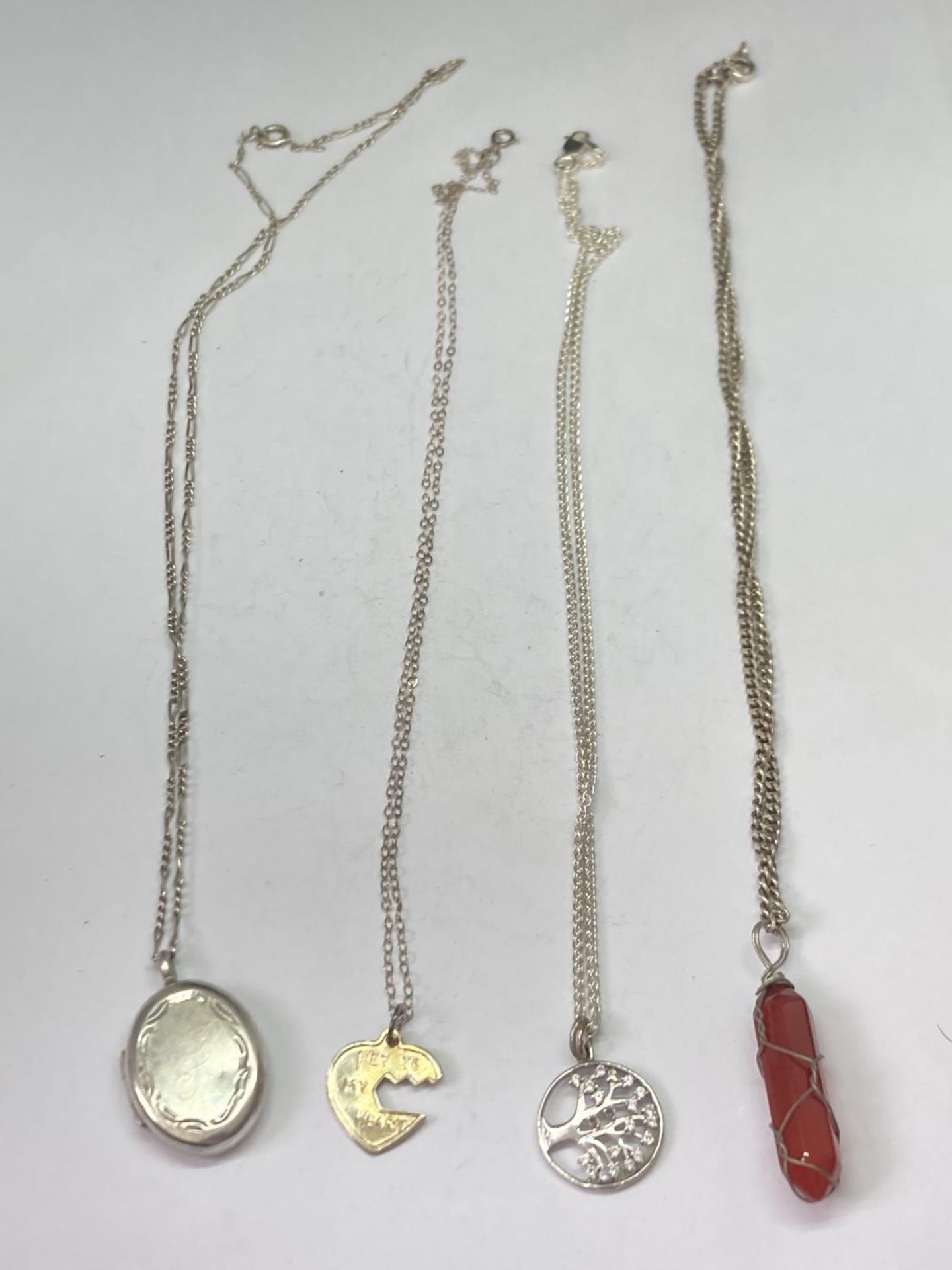 FOUR SILVER NECKLACES WITH PENDANTS